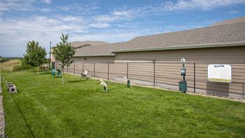 the backyard of a house with a fence and a dog park